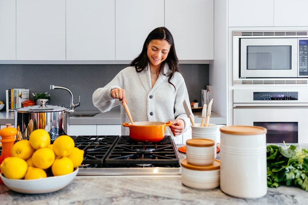 Certified appliance technician servicing a modern stainless steel kitchen appliance in Fishers, IN