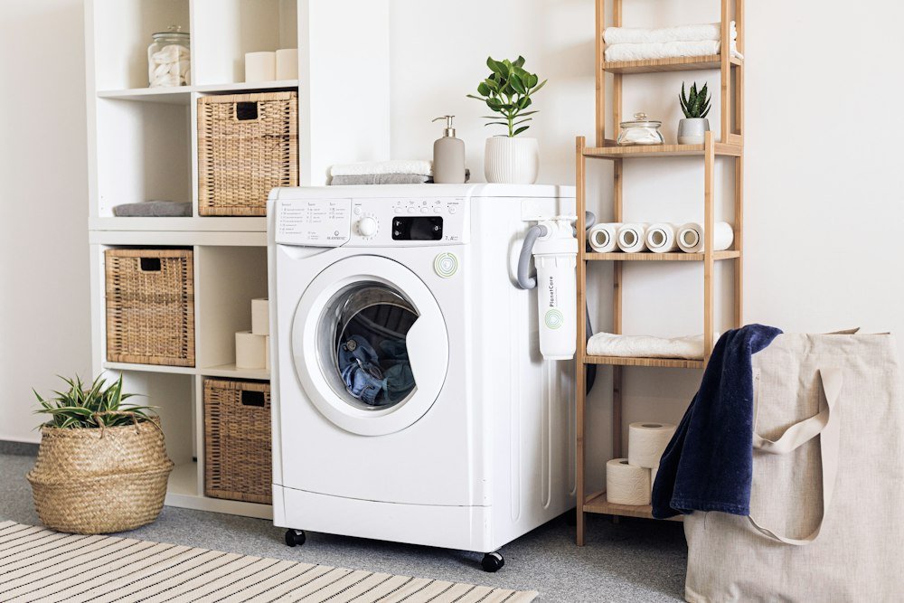 Professional appliance repair technician servicing a residential washer and dryer laundry pair in Westfield, IN